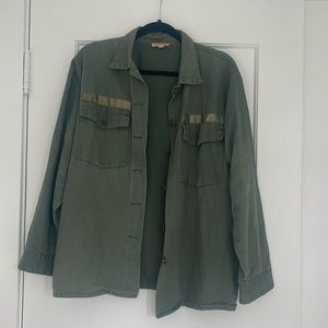 Olive green utility jacket with functional pockets, and buttons at the sleeves